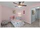Cozy bedroom features pink walls and a ceiling fan at 1939 Mostyn Ln, Apex, NC 27502