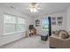 Neutral bedroom with ample natural light and a comfortable seating area at 1939 Mostyn Ln, Apex, NC 27502