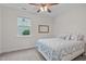 Cozy bedroom featuring a ceiling fan and a window for natural light at 1939 Mostyn Ln, Apex, NC 27502