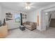 Bright bonus room with neutral colors, a ceiling fan and view to the staircase at 1939 Mostyn Ln, Apex, NC 27502