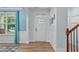 Bright entryway features hardwood floors, wainscoting, and a stylish front door at 1939 Mostyn Ln, Apex, NC 27502