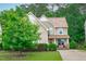 Two-story home featuring a covered front porch and nicely landscaped front yard at 1939 Mostyn Ln, Apex, NC 27502