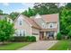 Charming two-story home featuring a manicured lawn, cozy front porch with seating, and an attached one car garage at 1939 Mostyn Ln, Apex, NC 27502