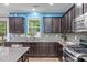 Beautiful kitchen with granite countertops, dark cabinets, and stainless steel appliances at 1939 Mostyn Ln, Apex, NC 27502