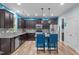 Stylish kitchen featuring a center island, stainless steel appliances, and dark wood cabinetry at 1939 Mostyn Ln, Apex, NC 27502