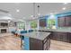 Open kitchen with granite island, stainless appliances, and breakfast bar seating at 1939 Mostyn Ln, Apex, NC 27502