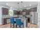 Modern kitchen with granite countertops, stainless steel appliances, and a breakfast bar at 1939 Mostyn Ln, Apex, NC 27502