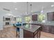 Open-concept kitchen featuring a granite-topped island and stainless-steel appliances at 1939 Mostyn Ln, Apex, NC 27502