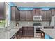 Well-equipped kitchen with stainless steel appliances, granite countertops, and dark wood cabinets at 1939 Mostyn Ln, Apex, NC 27502
