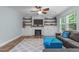 Comfortable living room featuring a cozy fireplace and built-in shelving at 1939 Mostyn Ln, Apex, NC 27502