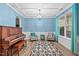 Bright and airy living room with a piano, comfortable seating, and stylish rug at 1939 Mostyn Ln, Apex, NC 27502
