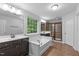 Luxury bathroom featuring a tub, a separate shower, and and sinks at 1939 Mostyn Ln, Apex, NC 27502