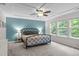 Spacious main bedroom with tray ceiling, large windows, and stylish furnishings at 1939 Mostyn Ln, Apex, NC 27502