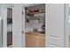 Walk-in pantry featuring custom wood shelving for optimal storage at 1939 Mostyn Ln, Apex, NC 27502