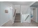 Carpeted staircase with wooden handrail connecting multiple levels in the home at 1939 Mostyn Ln, Apex, NC 27502