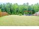 A spacious backyard with a lush lawn, bordered by woods at 1950 Menet St, Apex, NC 27502