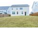 View of the backyard showing a large grassy area and the back of the house at 1950 Menet St, Apex, NC 27502