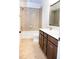 Neutral-toned bathroom with tiled floor, vanity, and a combined tub and shower at 1950 Menet St, Apex, NC 27502