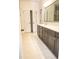 Well-lit bathroom with double vanity, neutral color scheme, and tiled floors at 1950 Menet St, Apex, NC 27502