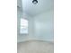 A simple, carpeted bedroom with a window and white walls, ready for personalization at 1950 Menet St, Apex, NC 27502