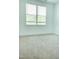 Bright bedroom featuring plush carpeting, a large window, and neutral decor provides a serene and inviting atmosphere at 1950 Menet St, Apex, NC 27502