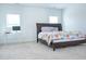 This bedroom includes carpet, two windows and a bed next to a white desk at 1950 Menet St, Apex, NC 27502