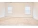Neutral-colored carpeted bedroom with white trim and natural light from a window at 1950 Menet St, Apex, NC 27502
