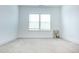 A clean, bright bedroom boasts neutral carpet, white walls, and a window at 1950 Menet St, Apex, NC 27502