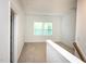 Upstairs hallway leading to a carpeted room with a bright window at 1950 Menet St, Apex, NC 27502