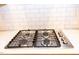 Close-up of the stainless steel gas cooktop and subway tile backsplash at 1950 Menet St, Apex, NC 27502