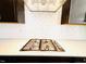 Close up of the stovetop with white tile backsplash and exhaust hood at 1950 Menet St, Apex, NC 27502