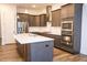 Modern kitchen with stainless steel appliances, a large island, and stylish cabinetry at 1950 Menet St, Apex, NC 27502