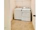 Laundry room with tile flooring featuring a washer and dryer and wire shelving at 1950 Menet St, Apex, NC 27502