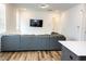 Open living area features a comfortable gray couch and a wall-mounted TV at 1950 Menet St, Apex, NC 27502