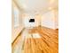 Spacious living room with hardwood floors, a wall-mounted TV, and natural light from windows at 1950 Menet St, Apex, NC 27502
