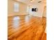 Spacious living room with hardwood floors, a wall-mounted TV, and natural light from windows at 1950 Menet St, Apex, NC 27502