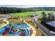 Playground with vibrant play structures and soccer fields, perfect for and families to enjoy at 1950 Menet St, Apex, NC 27502