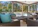 Inviting covered patio with comfortable seating, overlooking a beautiful pool and wooded area at 1950 Menet St, Apex, NC 27502