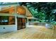 Expansive back deck with sliding glass doors, white trim, and surrounded by lush trees at 2004 Flagstone Pl, Raleigh, NC 27612