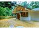 Spacious back deck featuring a cathedral ceiling, slider doors, and outdoor seating area at 2004 Flagstone Pl, Raleigh, NC 27612