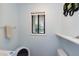 Clean bathroom featuring a unique window view, modern fixtures, and fresh decor at 2004 Flagstone Pl, Raleigh, NC 27612