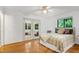 Cozy bedroom with hardwood floors and french doors that lead to a sunroom at 2004 Flagstone Pl, Raleigh, NC 27612