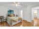 Bright bedroom with hardwood floors, a ceiling fan, and a wooded view at 2004 Flagstone Pl, Raleigh, NC 27612