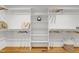 Organized walk-in closet with built-in shelving and hardwood floors at 2004 Flagstone Pl, Raleigh, NC 27612