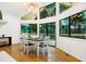Charming dining area with large windows offering serene views, with a modern light fixture at 2004 Flagstone Pl, Raleigh, NC 27612