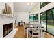 Warm dining area with a brick fireplace and views of the deck at 2004 Flagstone Pl, Raleigh, NC 27612