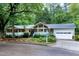 Inviting single Gathering home with lush landscaping and a charming blue front door at 2004 Flagstone Pl, Raleigh, NC 27612
