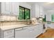 Updated kitchen boasts white cabinets, subway tile backsplash, and modern stainless appliances at 2004 Flagstone Pl, Raleigh, NC 27612