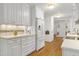 Spacious kitchen with white cabinets, stainless steel appliances, and hardwood floors throughout at 2004 Flagstone Pl, Raleigh, NC 27612