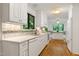 Bright kitchen features white cabinetry, stainless appliances, and hardwood flooring at 2004 Flagstone Pl, Raleigh, NC 27612